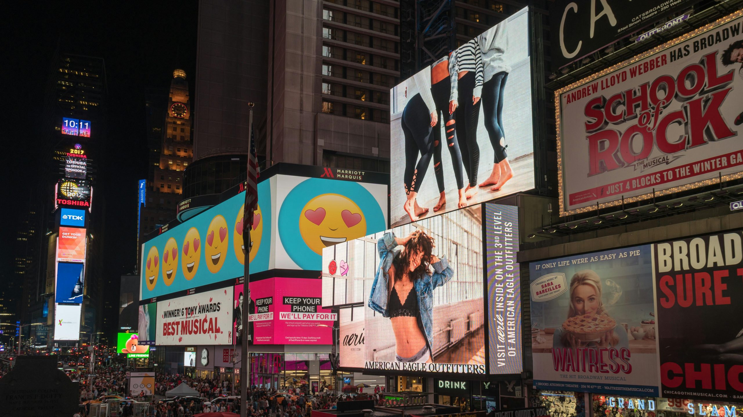 Home Colorful billboards light up New York City's iconic Times Square at night, with vibrant ads and bustling crowds.
